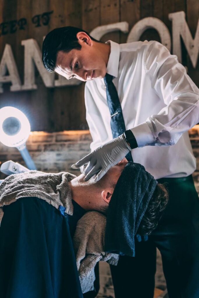 Michael Ramos, master barber at RMB Shave Parlor in Temecula, CA, performing a precision grooming service for a client